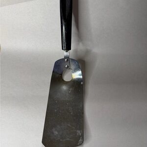 Vintage EKCO stainless steel cheese slicer with classic black handle.